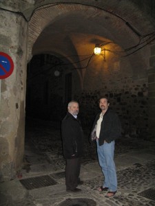 Manuel and Paco under a stone archway into the old part of the city.