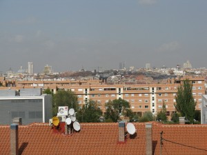 view The upper floor where Paco works in Madrid has a great view of the city. To the left, you can see the Tower of Madrid and the other large building (with yellow building-stuff hanging on it) that are on the Plaza de España.