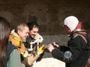 Antonino, Juan Miguel and Julio look at a piece of chainmail.