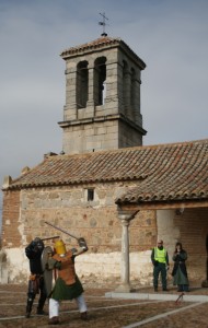 The group drove to another city, and we spent the day outside of this Church of the Virgin of the Assumption in Casalgordo (now part of Sonseca). In this photo Julio and Antonino are fighting with Gema and a local policeman watching.