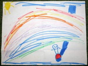 Eric waves beneath the rainbow.