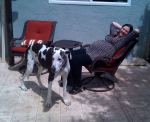Mary enjoys the new patio furniture on a cool morning. The chairs both rock...the better to enjoy the outdoors with our boys.
