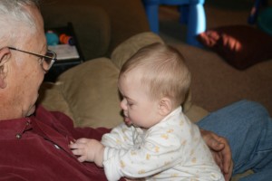 Dom tries to get the clothespin off Papa's pocket.