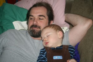 Dom naps on his daddy.