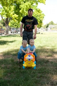 Dom (left) & Alex with Dad: It's tough pushing the lion on grass! (June 26, 2011)